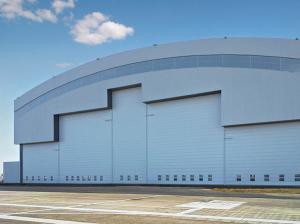 China Prefab Curve Roofing System Steel Aircraft Hangars With Electrical Slide Doors wholesale