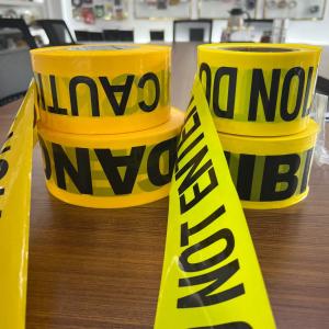 China PE Warning Tape CAUTION Traffic Safety Yellow Background Black Lettering Printed Non Adhesive Label Warning Isolation wholesale