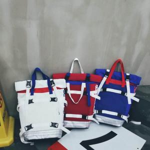 China Contrast color roll mouth portable travel backpack European and American large-capacity couple backpack wholesale